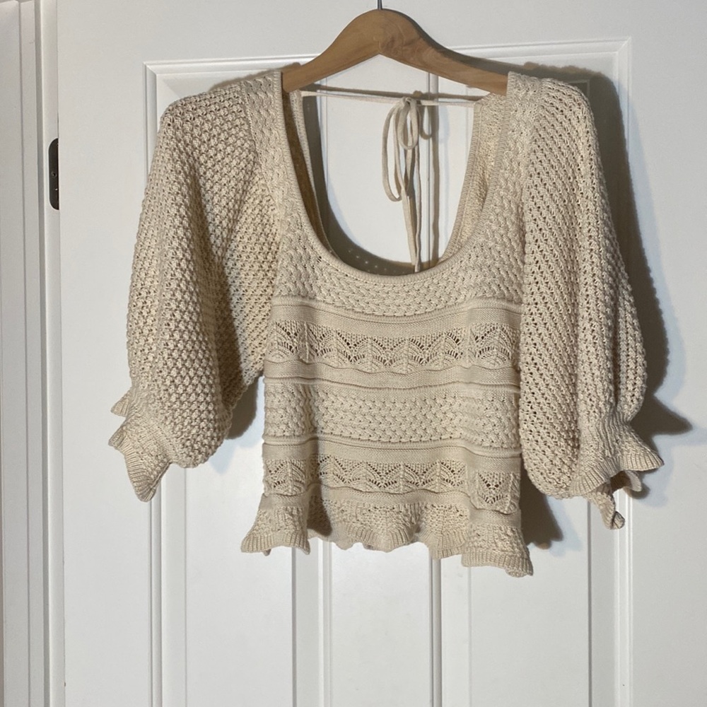 This is a very soft sweater the material is soft. It is beige size x small